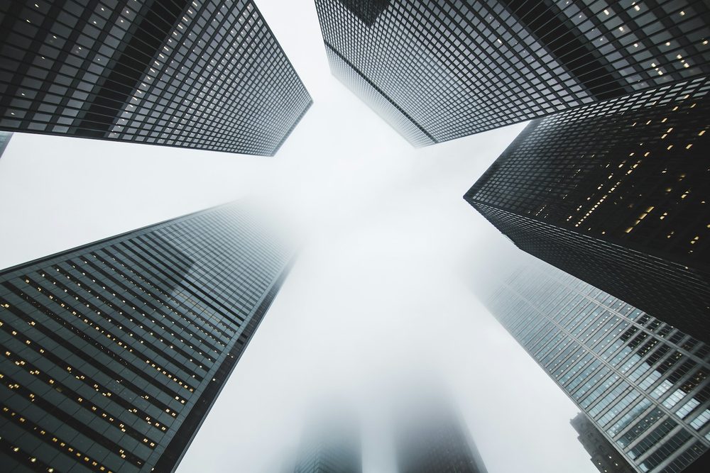 Glass office towers against a bright sky
